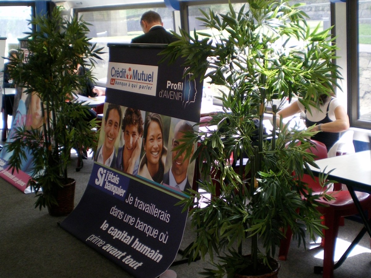 a room that has a sign on a plant